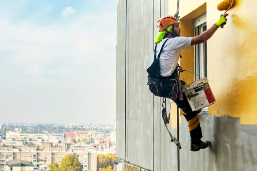 Rope-access painter on a tall building facade in Burbank